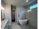 Modern bathroom featuring a freestanding tub, stylish tile, and a double vanity at 486 Broom Dr, Cumming, GA 30040