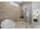 Spa-like bathroom features a glass shower and luxurious soaking tub at 486 Broom Dr, Cumming, GA 30040
