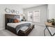 Cozy bedroom with a bed, stylish decor, and large windows for natural light at 486 Broom Dr, Cumming, GA 30040