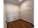 Walk-in closet with custom shelving and hardwood flooring at 486 Broom Dr, Cumming, GA 30040