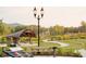Inviting community park with a stage, walking paths, manicured lawn, and lush landscaping at 486 Broom Dr, Cumming, GA 30040