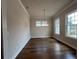 Formal dining room featuring hardwood floors, a modern chandelier, and ample natural light at 486 Broom Dr, Cumming, GA 30040