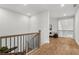 Upstairs hallway features hardwood floors and a view into the Gathering room at 486 Broom Dr, Cumming, GA 30040