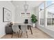 Bright home office features modern light fixture, hardwood flooring, and sun-filled windows at 486 Broom Dr, Cumming, GA 30040