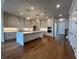 Spacious kitchen features a large island, custom cabinets, stainless appliances, and hardwood flooring at 486 Broom Dr, Cumming, GA 30040