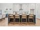 Stylish kitchen island with seating, complemented by white cabinetry and modern pendant lighting at 486 Broom Dr, Cumming, GA 30040