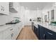 Gourmet kitchen with white cabinets, marble countertops, and stainless steel appliances at 486 Broom Dr, Cumming, GA 30040