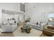 Open-concept living space with a kitchen view, comfortable seating, and ample natural light at 486 Broom Dr, Cumming, GA 30040