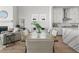 Open-concept living and dining area with hardwood floors, fireplace, and abundant natural light at 486 Broom Dr, Cumming, GA 30040