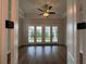 Bright living room with hardwood floors, ceiling fan, and french doors to outside at 486 Broom Dr, Cumming, GA 30040