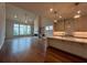 Bright open-concept living room boasts hardwood floors, fireplace, and a wall of windows overlooking the yard at 486 Broom Dr, Cumming, GA 30040