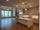 Bright open-concept living room boasts hardwood floors, fireplace, and a wall of windows overlooking the yard at 486 Broom Dr, Cumming, GA 30040