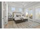 Bright main bedroom boasts tray ceilings, neutral tones, and private patio doors at 486 Broom Dr, Cumming, GA 30040