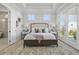 Bright main bedroom boasts tray ceilings, neutral tones, and private patio doors at 486 Broom Dr, Cumming, GA 30040