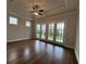 Home office with hardwood floors, large glass doors, tray ceiling, and lots of natural light at 486 Broom Dr, Cumming, GA 30040