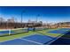 Vibrant green and blue tennis courts offer a fun and active recreation space at the Sawnee Village community at 486 Broom Dr, Cumming, GA 30040