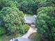 Aerial view of a home surrounded by lush greenery, showcasing its setting and curb appeal at 51 Muirfield Ct, Hiram, GA 30141