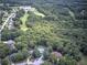 Aerial view of the home surrounded by mature trees and near the golf course at 51 Muirfield Ct, Hiram, GA 30141