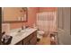 Well-lit bathroom with a modern vanity, complete toilet, and shower with curtain at 51 Muirfield Ct, Hiram, GA 30141