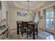 Elegant dining room with tray ceiling, modern chandelier, and large windows at 51 Muirfield Ct, Hiram, GA 30141