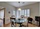 Dining room featuring a glass table, white plantation shutters, wainscotting, and wood floors at 51 Muirfield Ct, Hiram, GA 30141