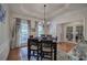 Stylish dining room with tray ceiling, modern chandelier, and hardwood floors at 51 Muirfield Ct, Hiram, GA 30141