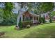 Beautiful home with landscaped lawn on a lush lot with mature trees and an inviting front porch at 51 Muirfield Ct, Hiram, GA 30141