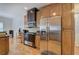 Traditional-style kitchen featuring stainless steel appliances, custom cabinetry, and hardwood floors at 51 Muirfield Ct, Hiram, GA 30141