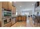 Open kitchen with stainless appliances, hardwood floors, granite countertops, and plenty of counter space at 51 Muirfield Ct, Hiram, GA 30141
