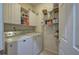 Functional laundry room with storage shelves and full-size washer and dryer at 51 Muirfield Ct, Hiram, GA 30141