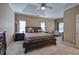 Spacious main bedroom with a ceiling fan, neutral carpet, and large windows at 51 Muirfield Ct, Hiram, GA 30141