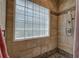 Detailed view of the walk-in shower, featuring a glass block window and stone accents at 51 Muirfield Ct, Hiram, GA 30141