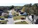 Aerial view of a home in a suburban neighborhood, showcasing the driveway and surrounding greenery at 704 Manor Ridge Dr, Loganville, GA 30052