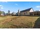 Expansive backyard with a trampoline and a wood fence at 704 Manor Ridge Dr, Loganville, GA 30052