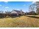 Spacious backyard with a lawn, wooden fence and trampoline at 704 Manor Ridge Dr, Loganville, GA 30052