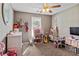 bedroom with a ceiling fan features a dollhouse and lots of toys at 704 Manor Ridge Dr, Loganville, GA 30052