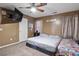 Carpeted bedroom with a ceiling fan and a large TV on the wall at 704 Manor Ridge Dr, Loganville, GA 30052