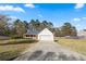 View of a single-story home with a long driveway, two-car garage, and spacious front yard at 704 Manor Ridge Dr, Loganville, GA 30052