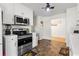 This kitchen has stainless steel appliances and a view into another room at 704 Manor Ridge Dr, Loganville, GA 30052