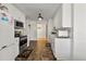 Kitchen with stainless appliances, a tile backsplash, and a view of the hallway at 704 Manor Ridge Dr, Loganville, GA 30052