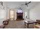 Bright living room featuring a brick fireplace, ceiling fan, and neutral-toned carpet at 704 Manor Ridge Dr, Loganville, GA 30052
