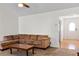 Comfortable living room with carpet, a sectional sofa, and easy access to the foyer at 704 Manor Ridge Dr, Loganville, GA 30052
