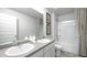 Bright bathroom featuring double sink vanity and combined bathtub shower at 12106 Conrad Cir, Hampton, GA 30228