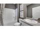 Well-lit bathroom showcasing a combined tub and shower, toilet, and vanity with framed artwork at 12106 Conrad Cir, Hampton, GA 30228