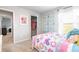 Bright bedroom featuring colorful decor, plush carpet, and a closet with open door at 12106 Conrad Cir, Hampton, GA 30228
