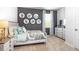 Comfortable bedroom with decorative wall art, side table, and a window at 12106 Conrad Cir, Hampton, GA 30228