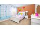 Bright bedroom with colorful decor, including floral wall art and vintage blue paneled doors at 12106 Conrad Cir, Hampton, GA 30228