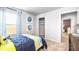Carpeted bedroom with blue accent wall, window with blinds, and closet with open door at 12106 Conrad Cir, Hampton, GA 30228
