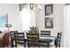 Open dining area featuring wood floors, chandelier, and an inviting view into the living space at 12106 Conrad Cir, Hampton, GA 30228