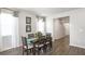 Dining room with wood floors and a table with six chairs under a modern chandelier at 12106 Conrad Cir, Hampton, GA 30228